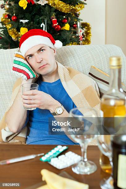 Man In Red New Year Hat Stuping Towel To Head Stock Photo - Download Image Now - Adult, Failure, Forehead