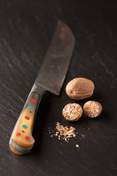 istock Nutmeg on  slate chalkboard and vintage knife 518261599