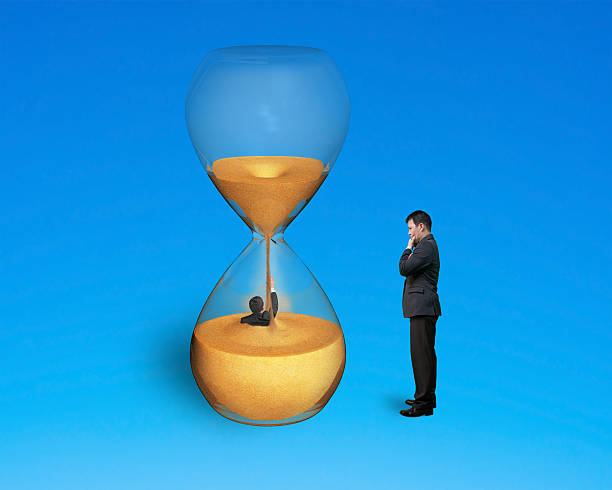 istock boss oversee employee flooded in hourglass 518261991