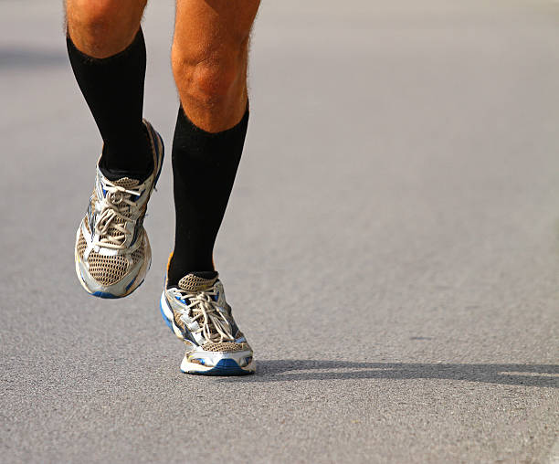 istock runner with sneakers during the Marathon on paved road 518262235