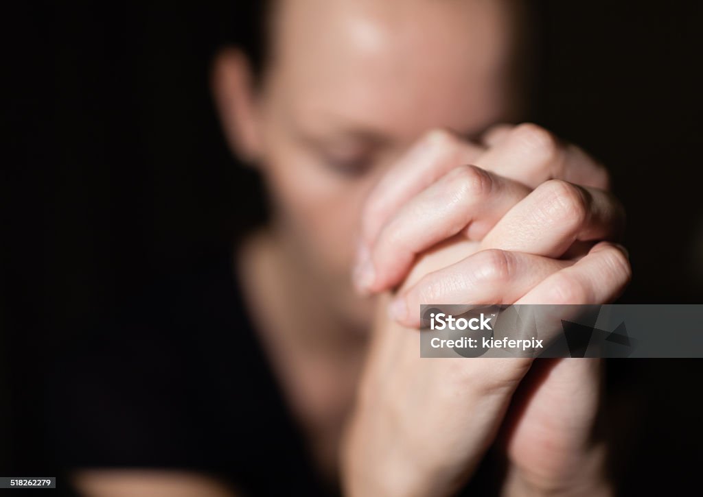 Woman praying Young woman praying. Praying Stock Photo