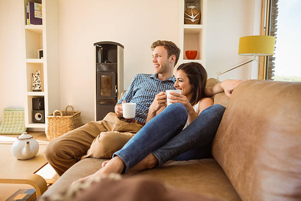 istock Happy young couple relaxing on the couch 518263537