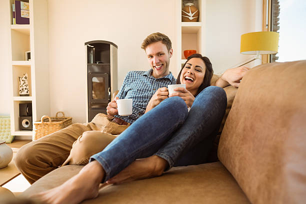 istock Happy young couple relaxing on the couch 518263539
