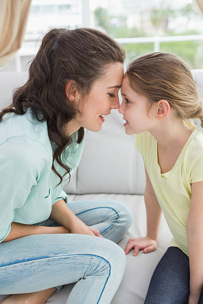 istock Cute mother and daughter on the couch 518263997