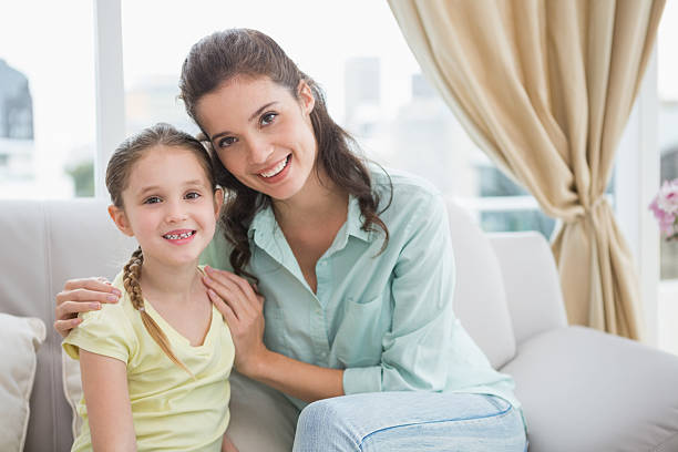 istock Cute mother and daughter smiling at camera 518264565
