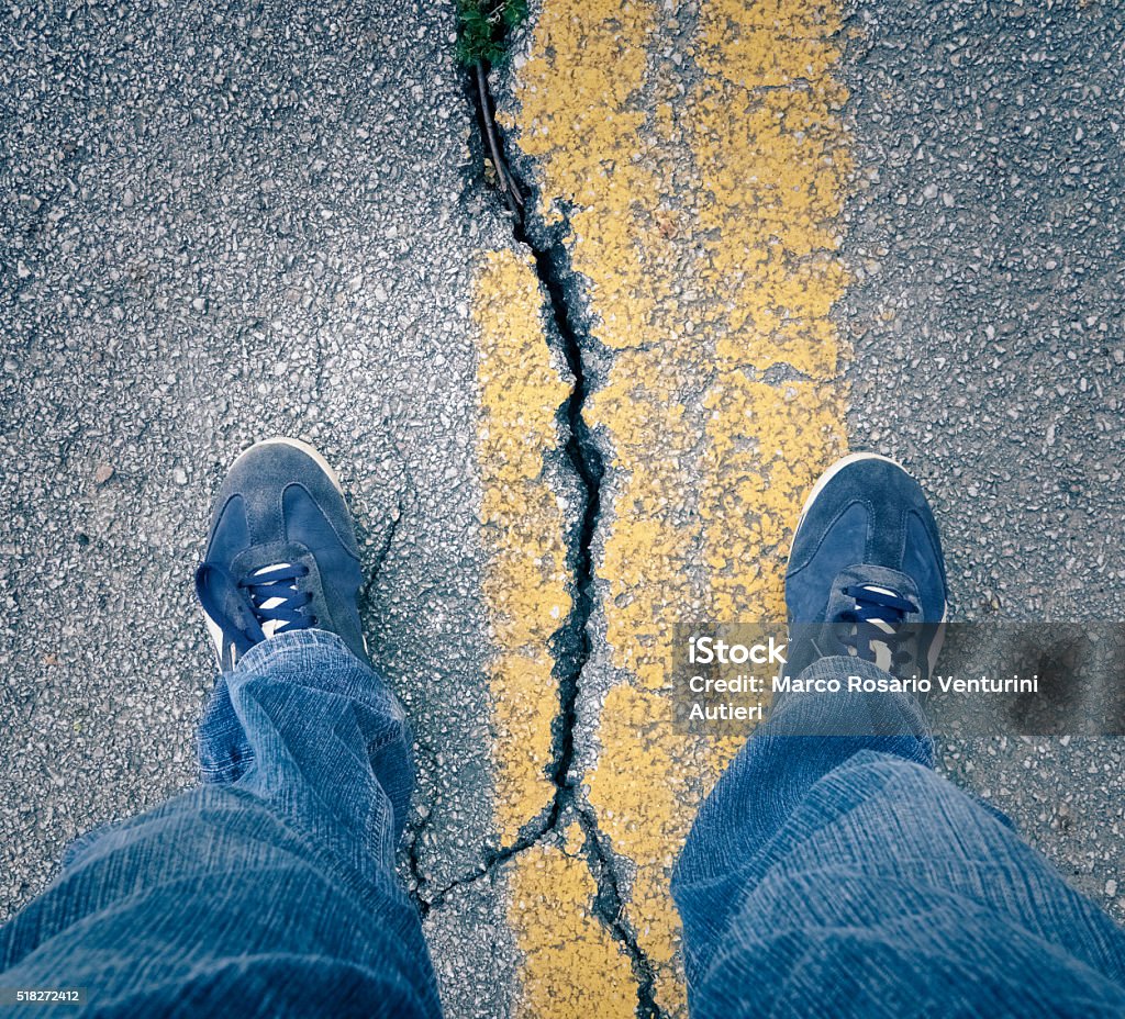 standing-with-my-feet-across-large-crack-in-the-asphalt.jpg