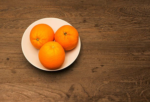 istock three oranges in a white porcelain bowl 518273710