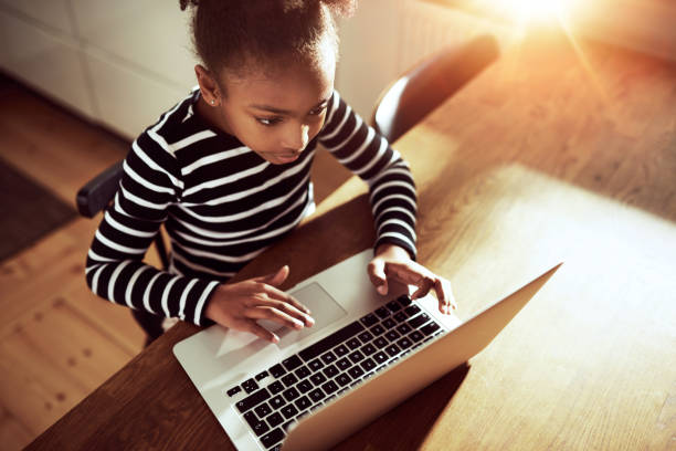 istock Cute young girl surfing the web 518273996