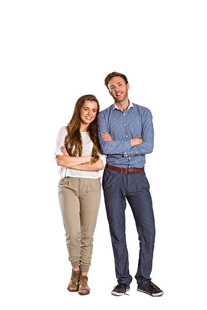 istock Smiling young couple with arms crossed 518274651