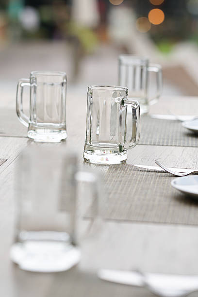 istock empty glass mug, cutlery and white dish 518275254