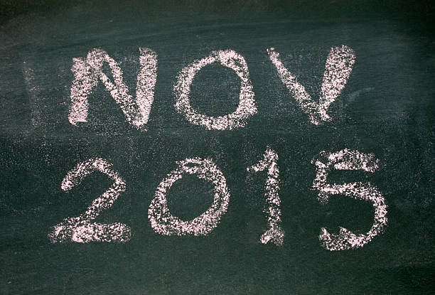 istock Year number 2015 and nov written with chalk on blackboard 518275273