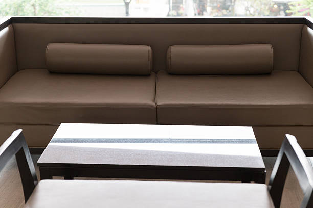 istock wooden sofa with brown leather cushion 518278212