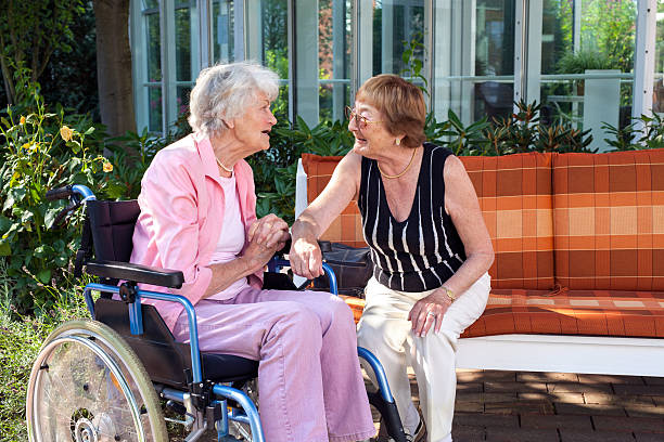 istock Two senior ladies chatting on a garden bench. 518279669