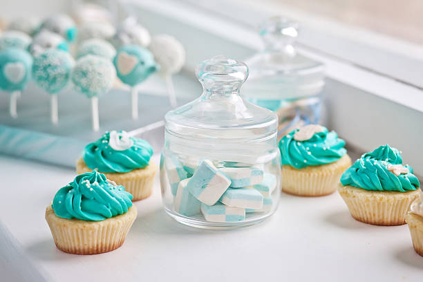 Candy bar at Birthday party.Marshmallows in a glass and cupcakes