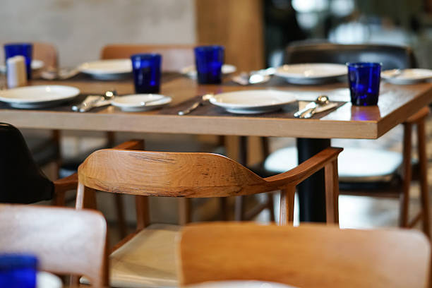 istock dish, spoon, fork and blue glass on wooden table 518280652