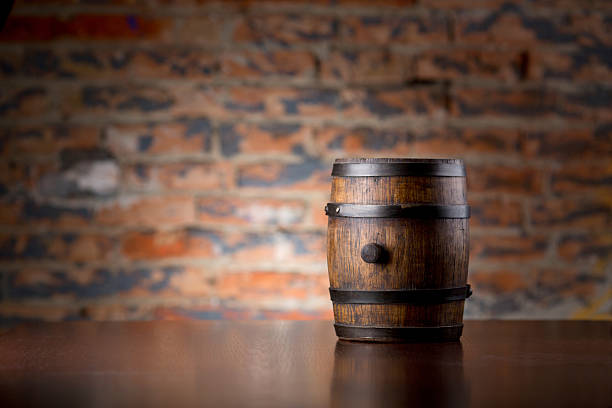 istock Old wooden barrel on a wood table 518281149