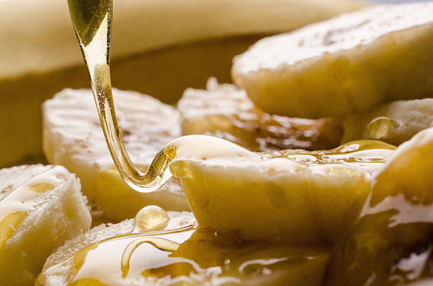 istock Pouring honey over ripe banana slices 518281429