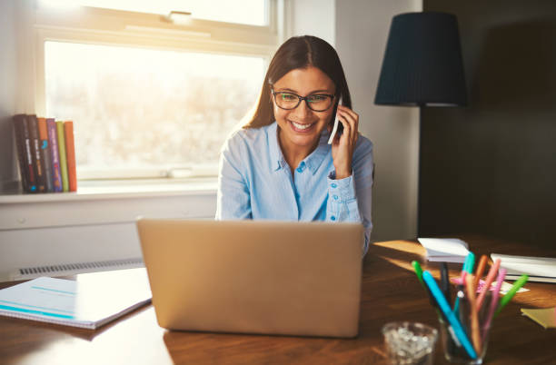 istock Smiling woman working at laptop 518281940