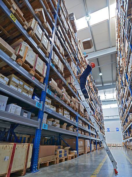 Man looking up at box falling on him, warehouse Man looking up at boxes falling on him, warehouse (blurred motion) person falling backwards stock pictures, royalty-free photos & images
