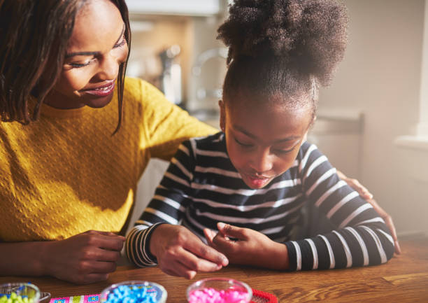 istock Happy mother and child working with beads 518282644