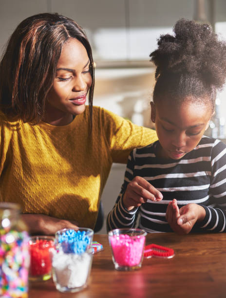 istock Cute girl choosing beads from hand 518282712