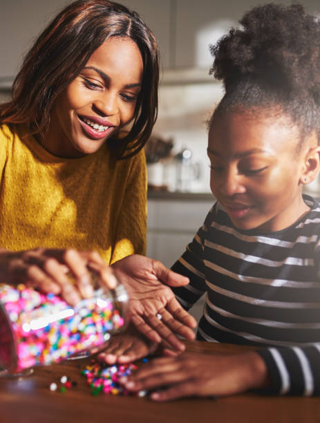 istock Mother pouring beads in palm for child 518282984