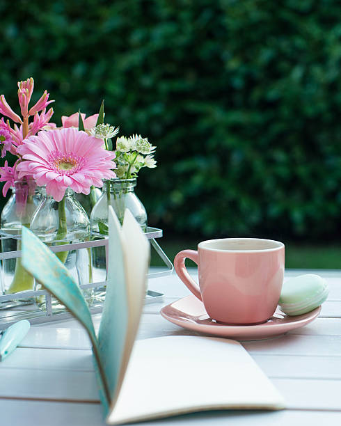 istock Cup of espresso coffee with macaroon and flowers. 518284062