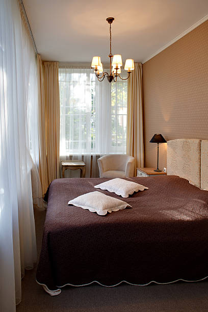istock Narrow classic style hotel room with big windows 518290841