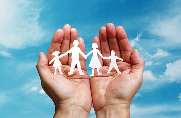 istock Paper chain family protected in cupped hands 518291905