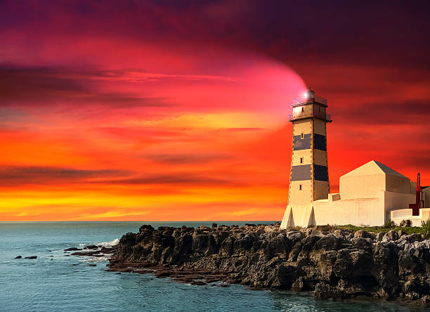 istock Lighthouse at sunset, purple seascape. 518295973