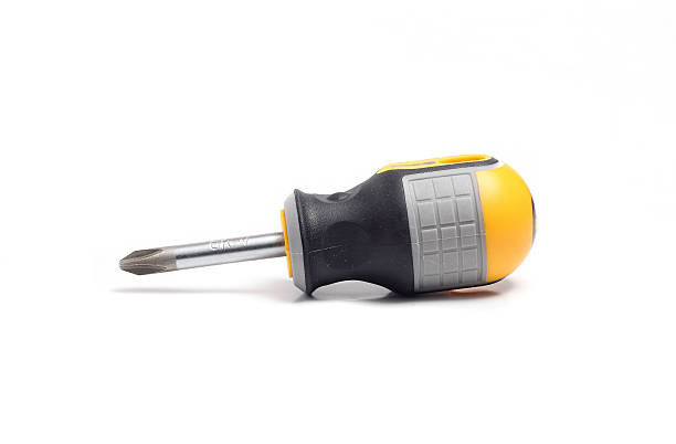 piccolo cacciavite phillips giallo con impugnatura nera - screwdriver isolated phillips work tool foto e immagini stock