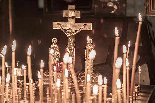 istock Icon lamp with Jesus on cross and burning candles 518297811