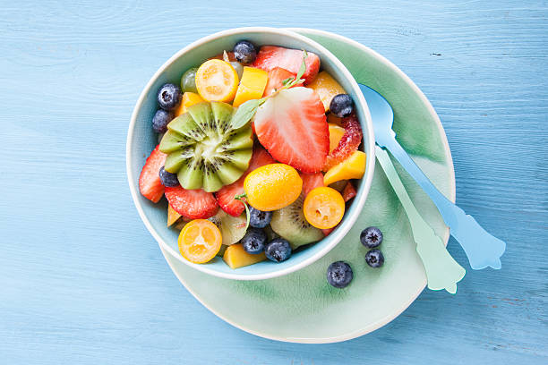 Ceramic cup with fresh fruit salad stock photo