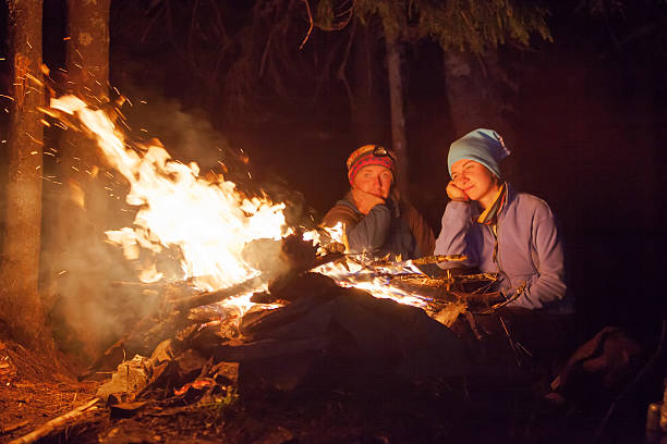 istock People near campfire in forest 518305772
