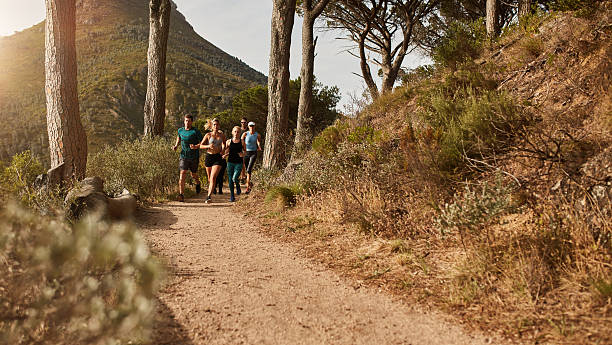 istock Athletes running together through trails on the hillside 518306594