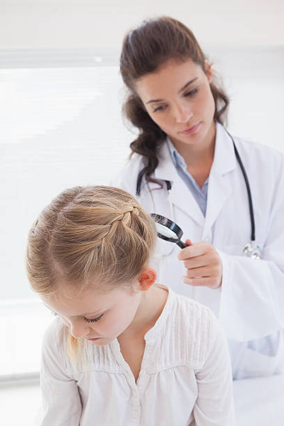 istock Doctor examining patient with magnifying glass 518307175
