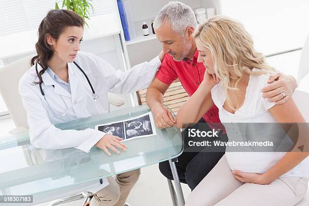 Doctor And Nervous Patient Examining Ultrasound Stock Photo - Download Image Now - Anxiety, Doctor, Pregnant