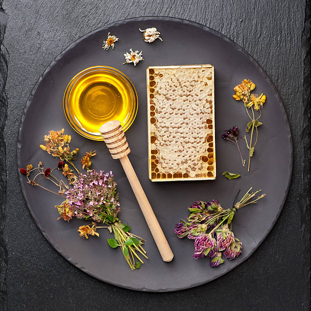 istock Honey jar, honeycomb and dried herbs 518308241