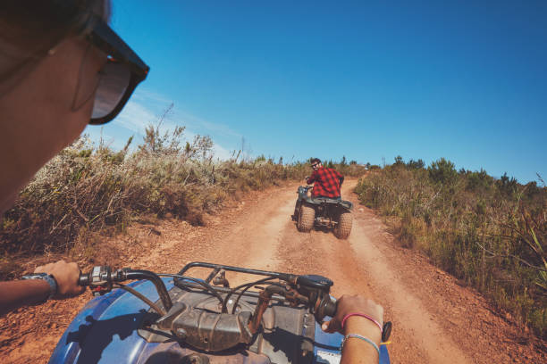 istock Young people driving quad bikes 518308318