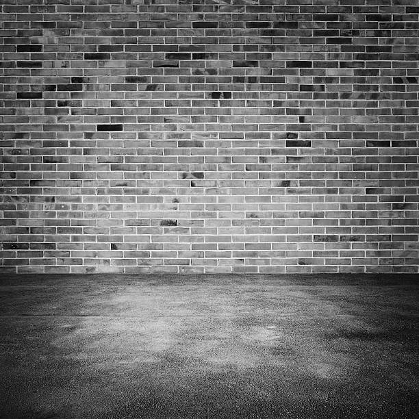istock Interior with old dark brick wall and asphalt floor 518308348