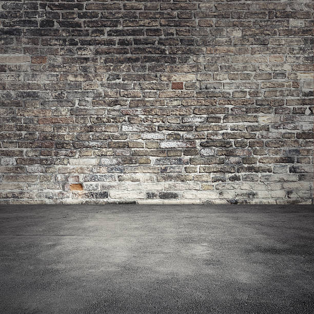 istock Background with dark old brick wall and asphalt 518308720
