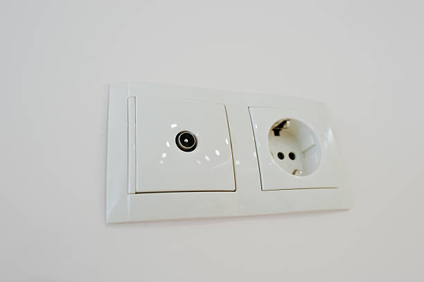 Twin electric socket with tv plug at the wall Twin electric socket with tv plug at the wall Faceplate stock pictures, royalty-free photos & images