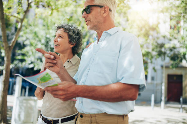 istock Couple of senior tourists reading a map 518308904
