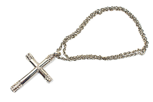 istock Silver christian cross necklace isolated on white 518309279