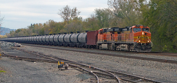 Amsterdam, NY,US - October 13, 2014: BNSF locomotives on CSX tracks pull a string of tank cars in upstate NY