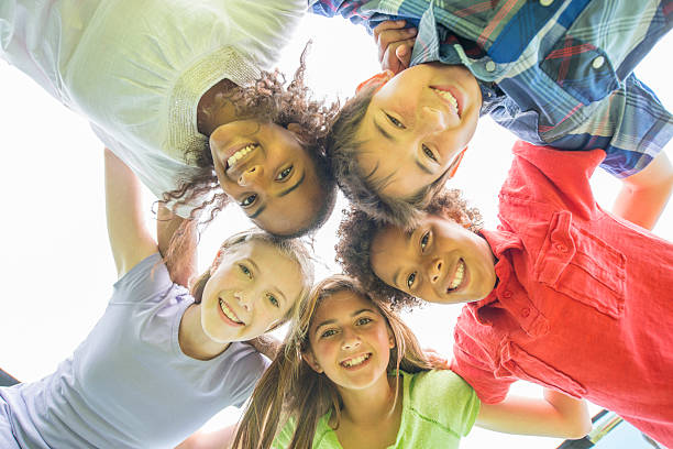 istock Smiling Friends Standing in a Huddle 518323124