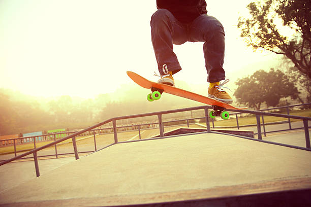 istock skateboarding legs at skatepark 518323588
