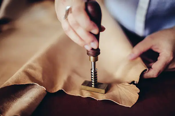 Confident craftswoman working in her workshop