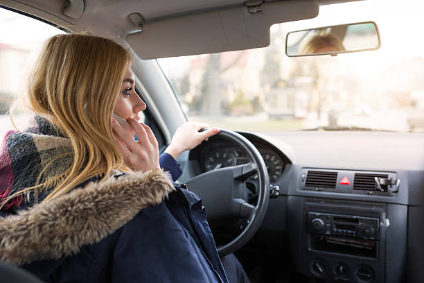 istock Girl driving and talking on the mobile 518324450