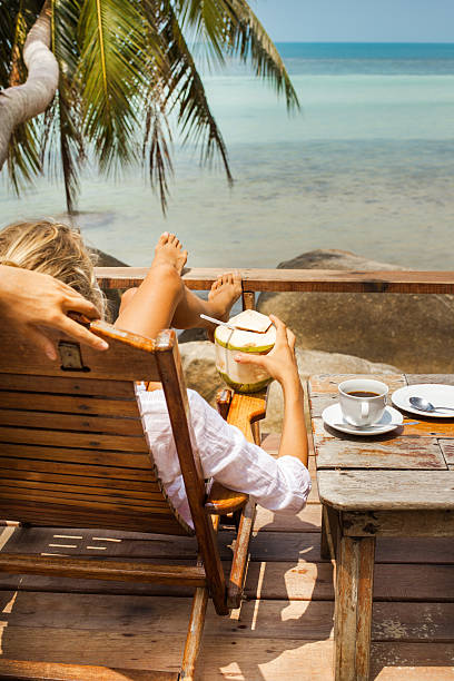 istock Young woman enjoys drinking coffee and coconut 518325060